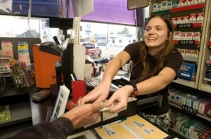 Cathy Layman  |  Times Photo xxxxxxxx: Admiral Gas Station cashier Storm Ainsely makes change for happy customers. Gas prices have been heading down, to the delight of motorists.  Regular gas is $2.01 at the Admiral gas station at 212 S. Euclid Ave. Shot Friday, November 7, 2008